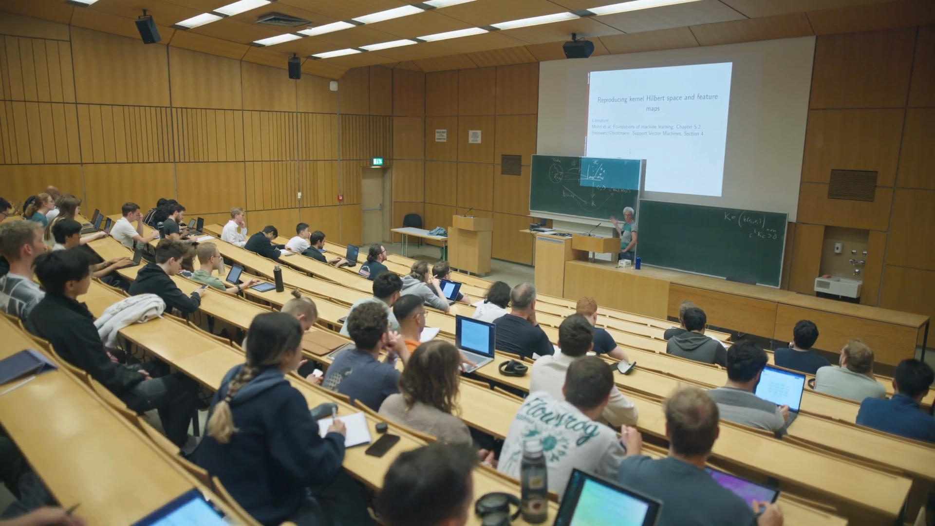 A machine learning lecture with students in a lecture hall